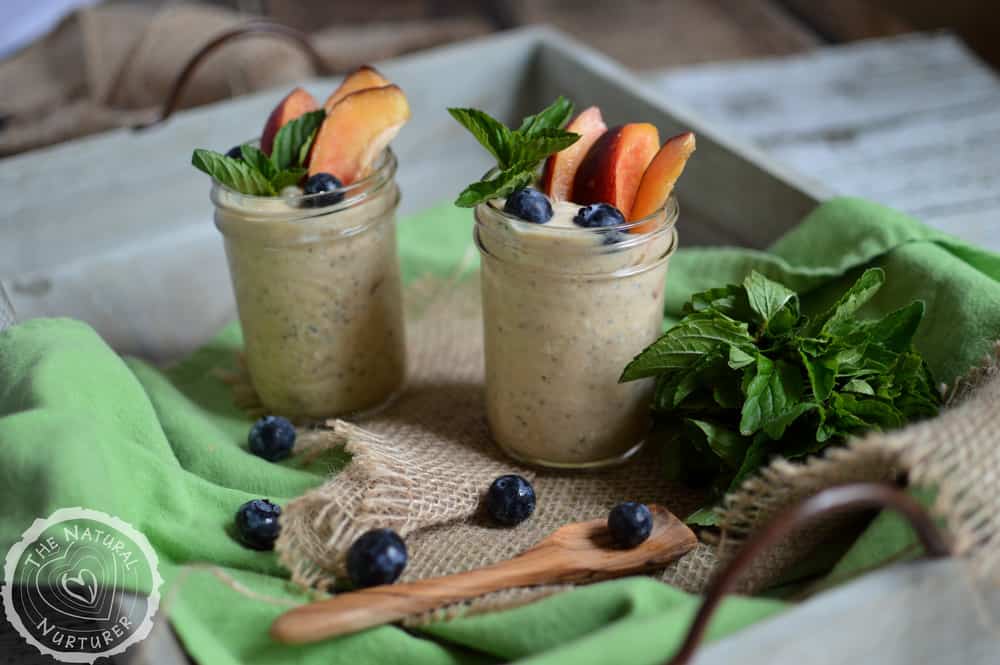 Peaches & Cream Overnight Oats served in two jars in a big grey tray.