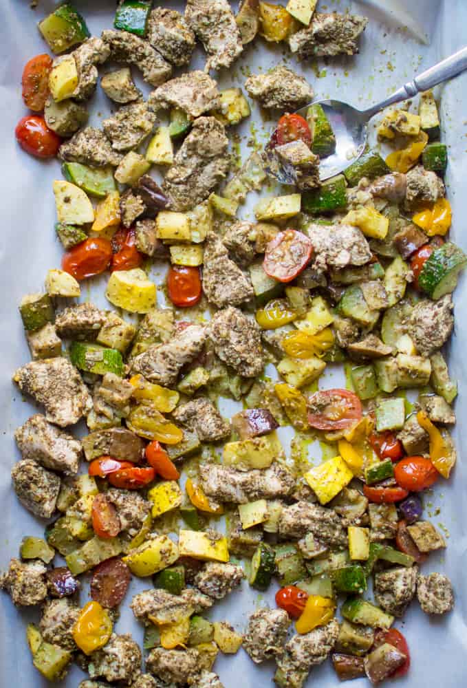 One-Sheet Pan Pesto Chicken & Summer Veggies spread out in a big sheet pan