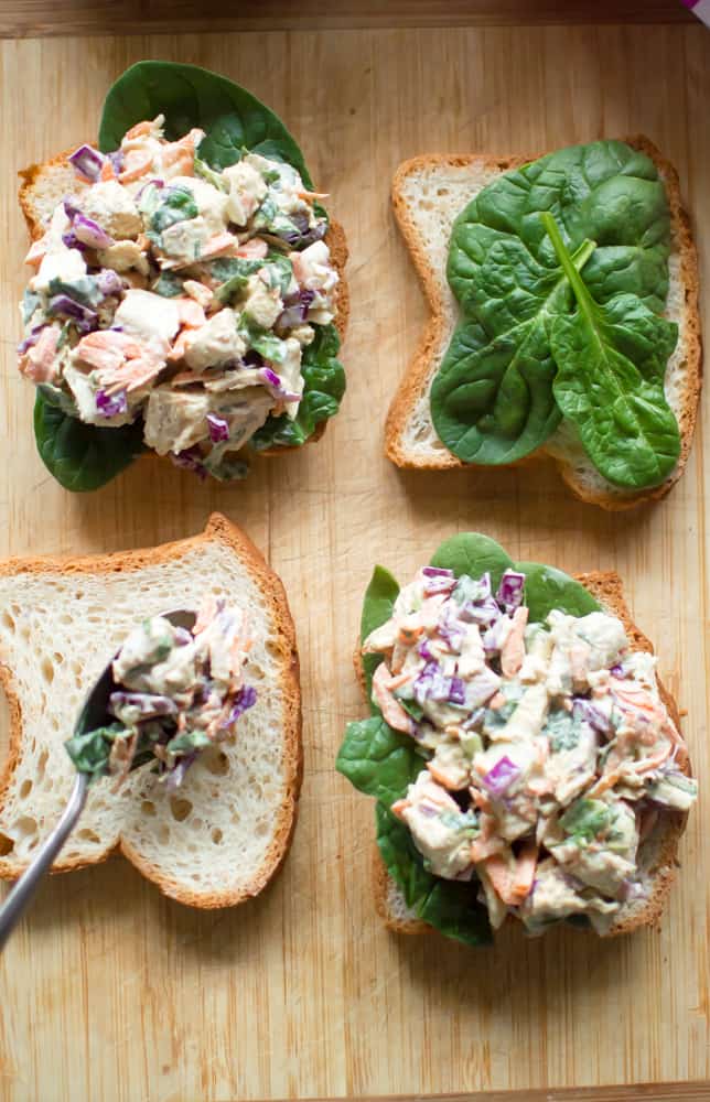 Four big pieces of bread with the most delicious veggie-loaded spring chicken salad on top