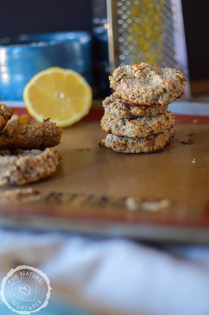 A stack of healthy and delicious Paleo Lemon Breakfast Cookies with a lemon wedge blurred in the background