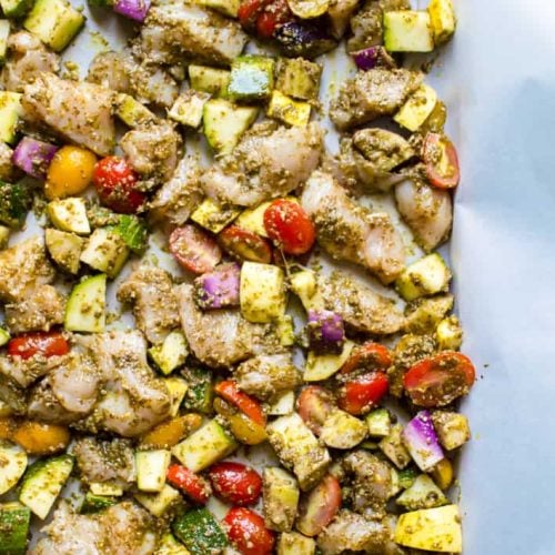 Closeup on the delicious One-Sheet Pan Pesto Chicken & Summer Veggies in a pan