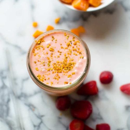 Overhead on the healthy and delicious Sunrise Butternut Squash Smoothie with frozen strawberries around the jar
