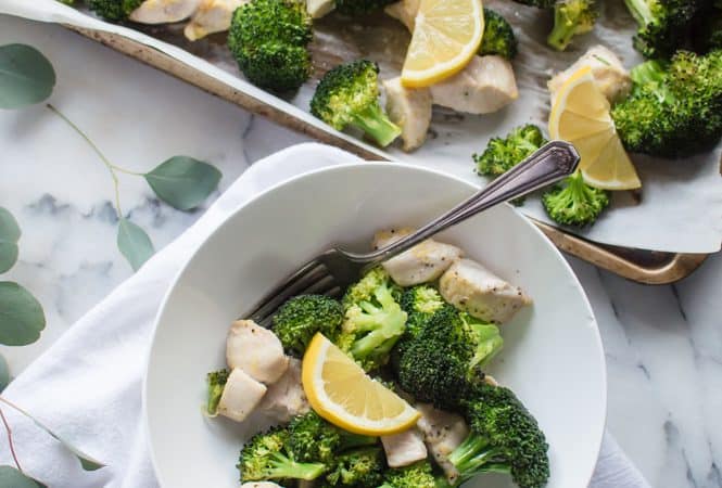 Overhead on the delicious Whole30 Lemon Chicken & Broccoli served in a white bowl with more chicken in a sheet-pan nearby