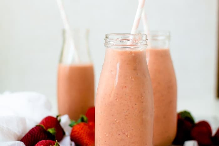 Vegan and dairy-free Vitamin C Immune Boosting Smoothie made from strawberries, red bell peppers and banana and served in tall jars with straws inside them.