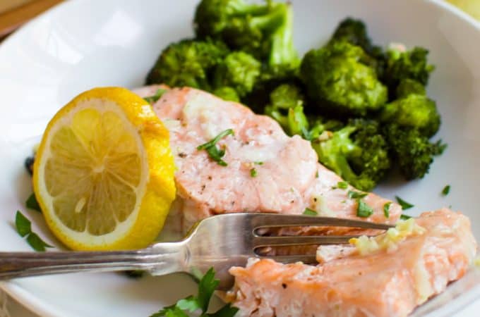 This One-Sheet Roasted Garlic Salmon & Broccoli is easy, quick, and full of flavor! A complete & delicious dinner that is Whole30, gluten free, and dairy free made entirely on one sheet pan….could it get any better?