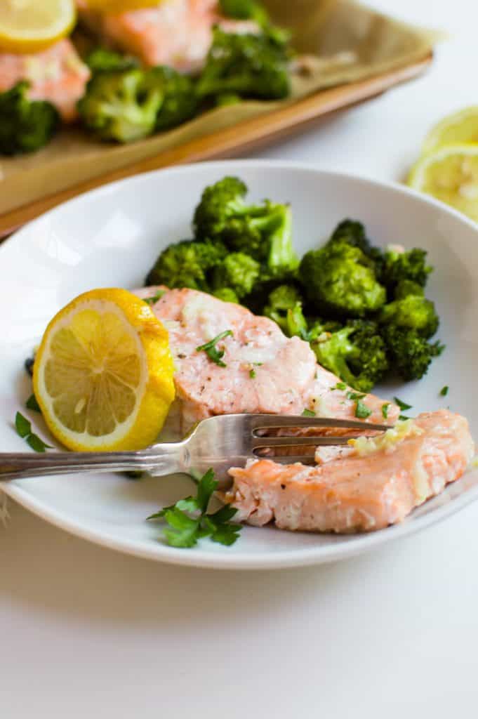 This One-Sheet Roasted Garlic Salmon & Broccoli is easy, quick, and full of flavor! A complete & delicious dinner that is Whole30, gluten free, and dairy free made entirely on one sheet pan….could it get any better?