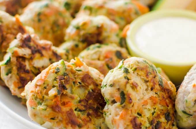 Veggie-loaded chicken bites ready and served with sauce ona white plate, looking absolutely delicious and inviting