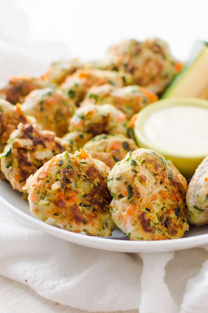 Veggie-loaded chicken bites ready and served with sauce ona white plate, looking absolutely delicious and inviting