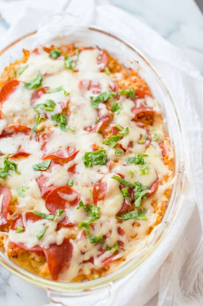 This Spaghetti Squash Pizza Casserole is easy to make and true comfort food. Loaded with veggies, protein and flavor...it is going to become a dinner staple.  Gluten free + veggie-loaded.