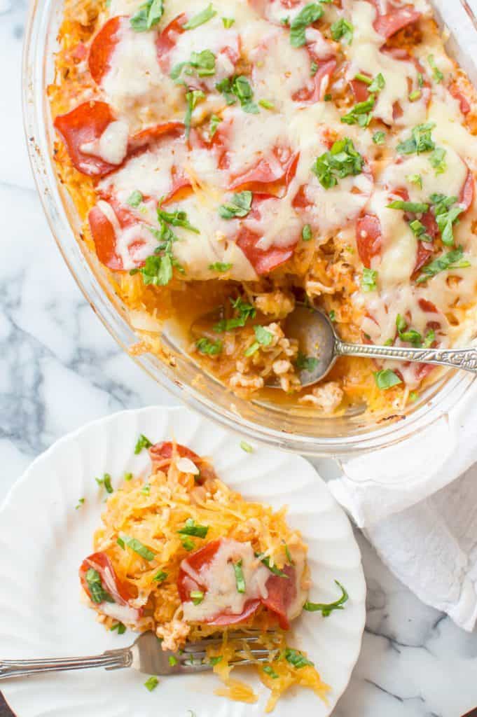This Spaghetti Squash Pizza Casserole is easy to make and true comfort food. Loaded with veggies, protein and flavor...it is going to become a dinner staple.  Gluten free + veggie-loaded.