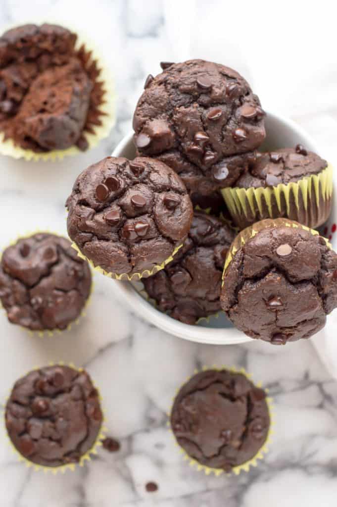 Closeup on healthy chocolate muffins in a small white bowl - one of the 15 healthy muffin recipes for kids