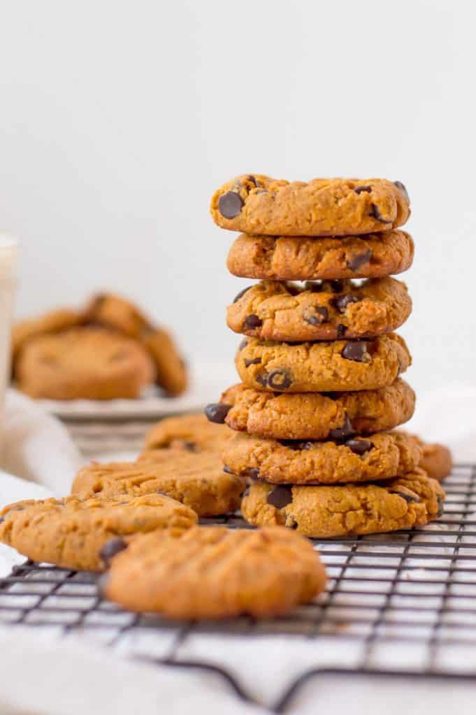 A big tower of Vegan Peanut Butter Cookies straight out of the oven. The tower consists of 7 cookies looking extra delicious.