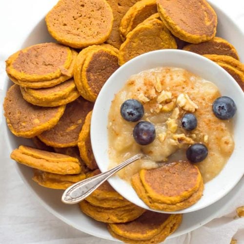 Healthy Sweet Potato Pancakes served with puree, blueberries and a metal spoon on top