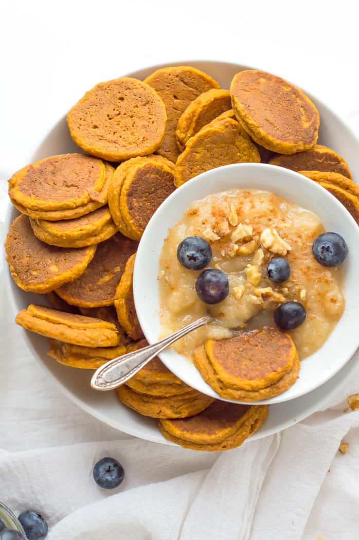 Healthy Sweet Potato Pancakes served with puree, blueberries and a metal spoon on top
