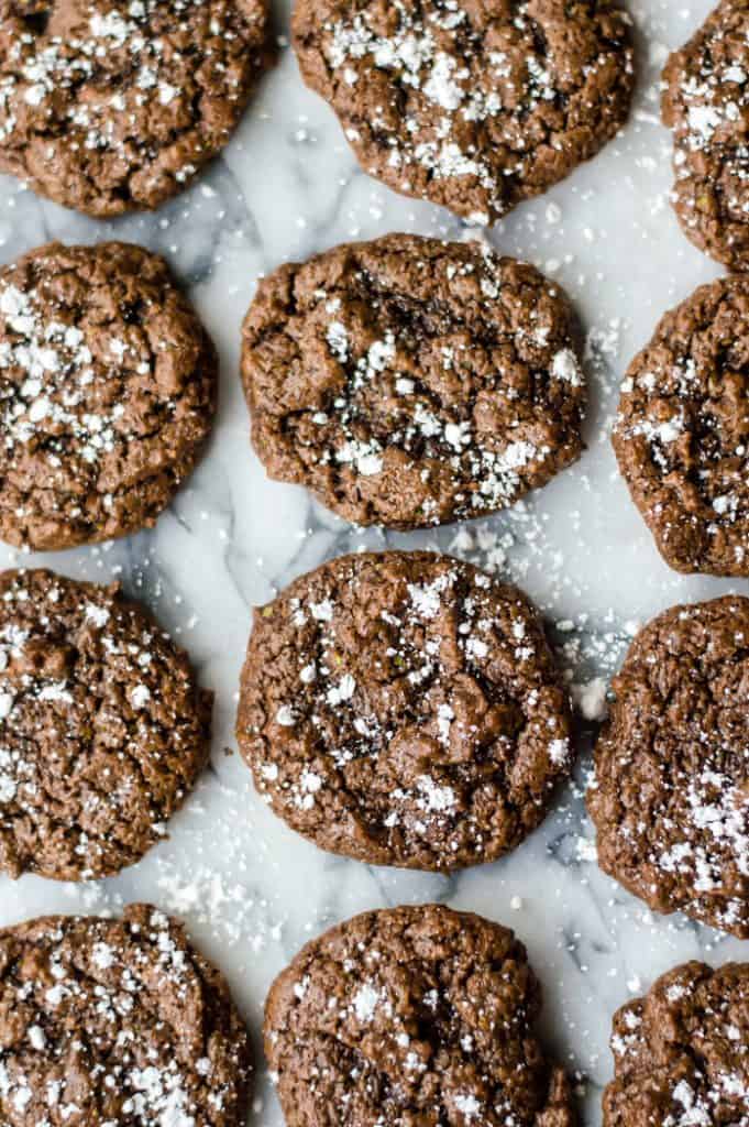 chocolate zucchini cookies cooling on a marble surface