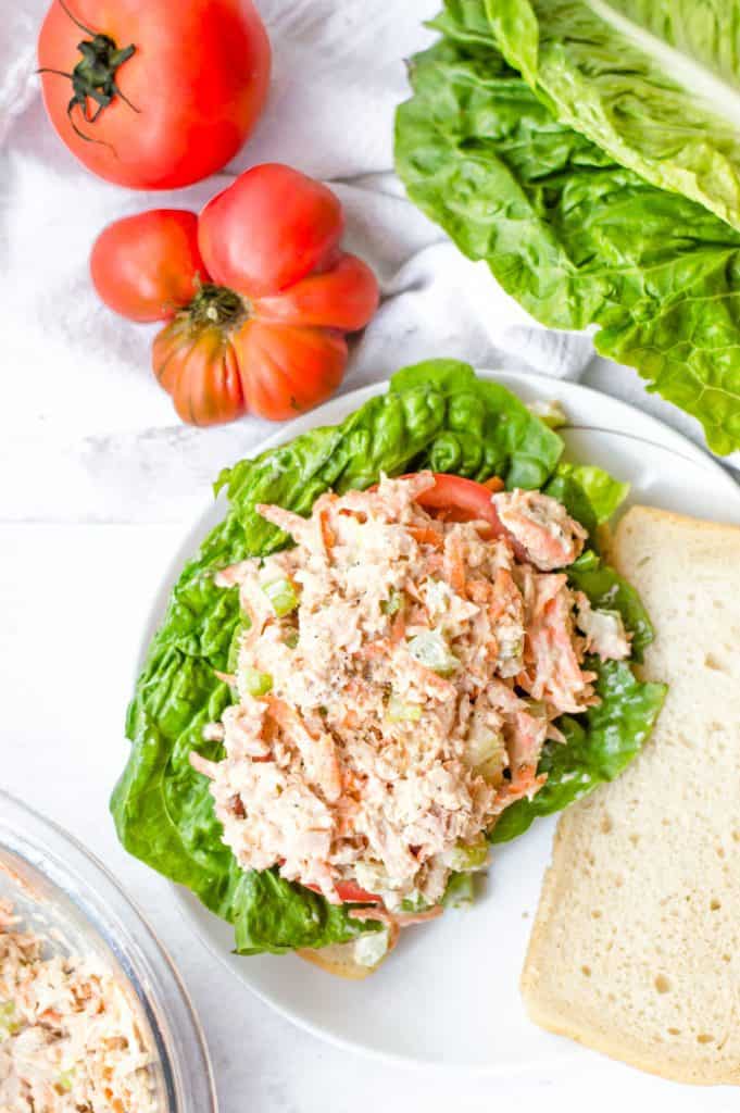 healthy tuna salad recipe on an open faced sandwich with lettuce and tomato