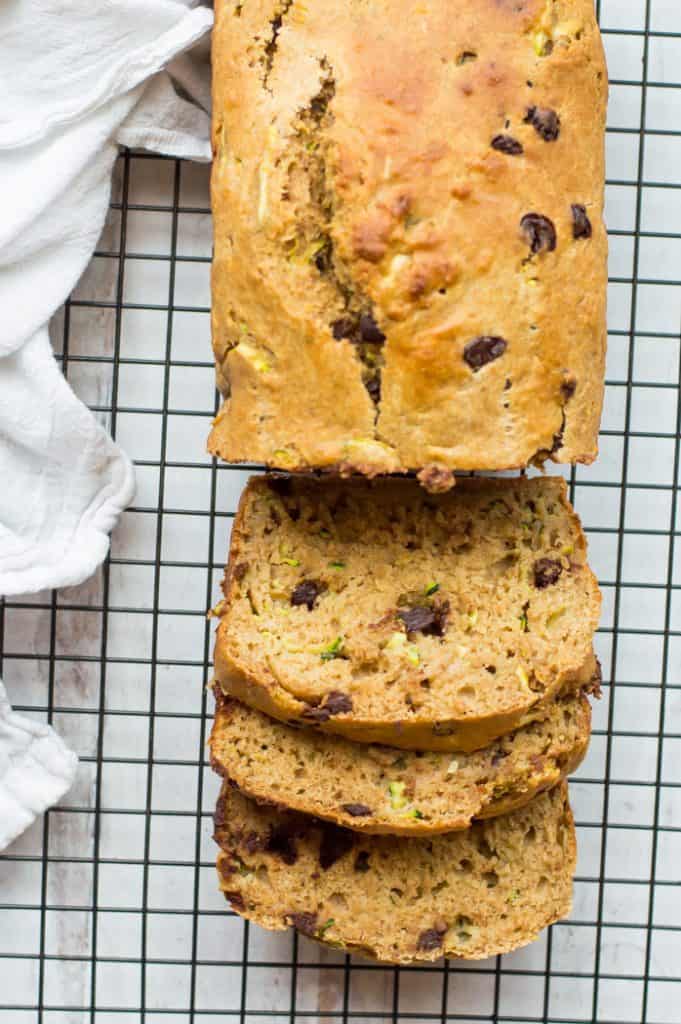 Healthy zucchini bread on cooling rack, partially sliced