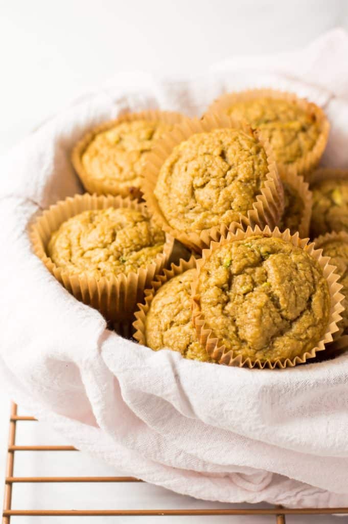 Healthy Zucchini Lemon Muffins in a basket with white cloth