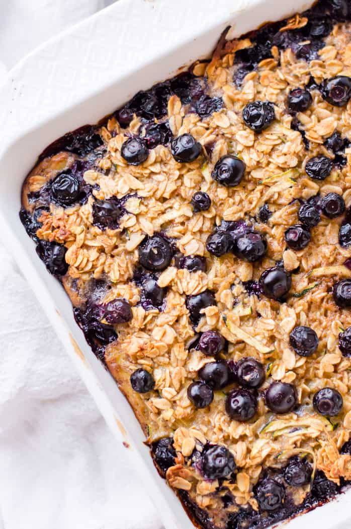 Zucchini blueberry baked oatmeal, fresh from the oven and sitting on a white napkin. 