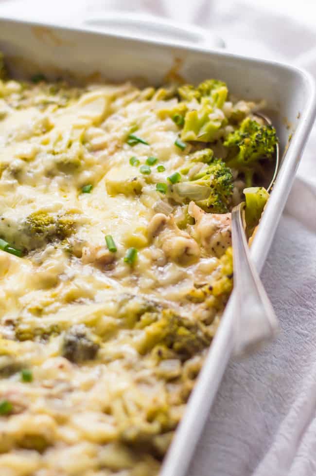 Chicken broccoli casserole fresh from the oven and on the table. A spoon is in the casserole.