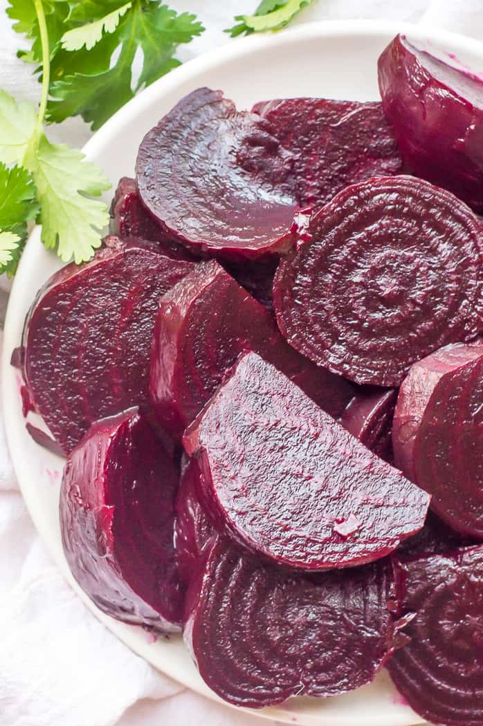 Roasted beets in a bowl after being peeled and sliced. 