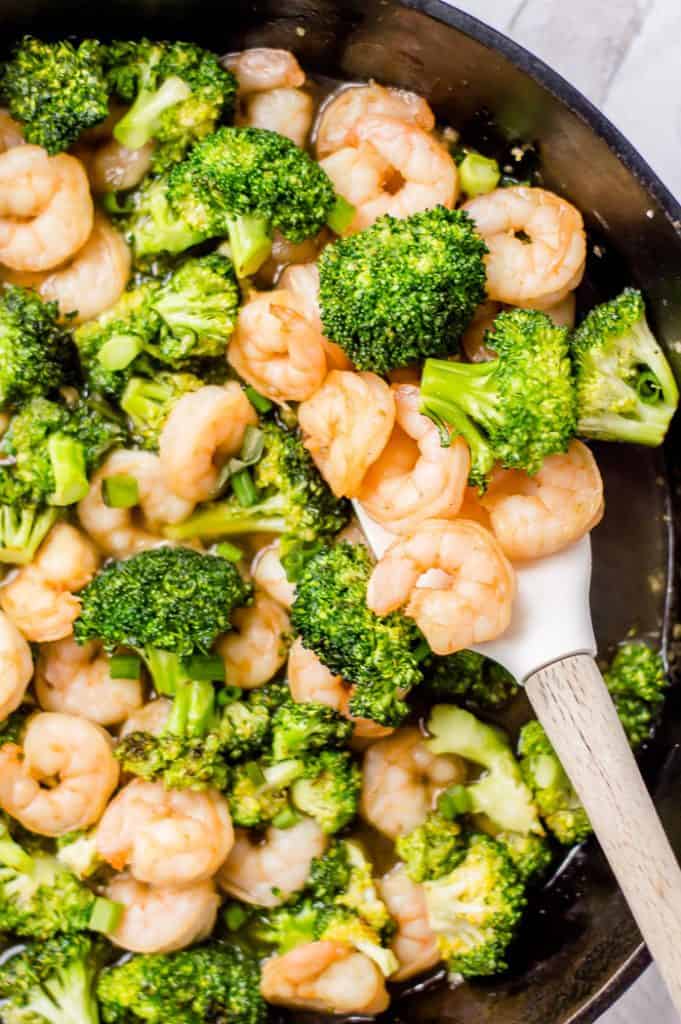 Easy garlic shrimp and broccoli in a cast iron with a spatula. 
