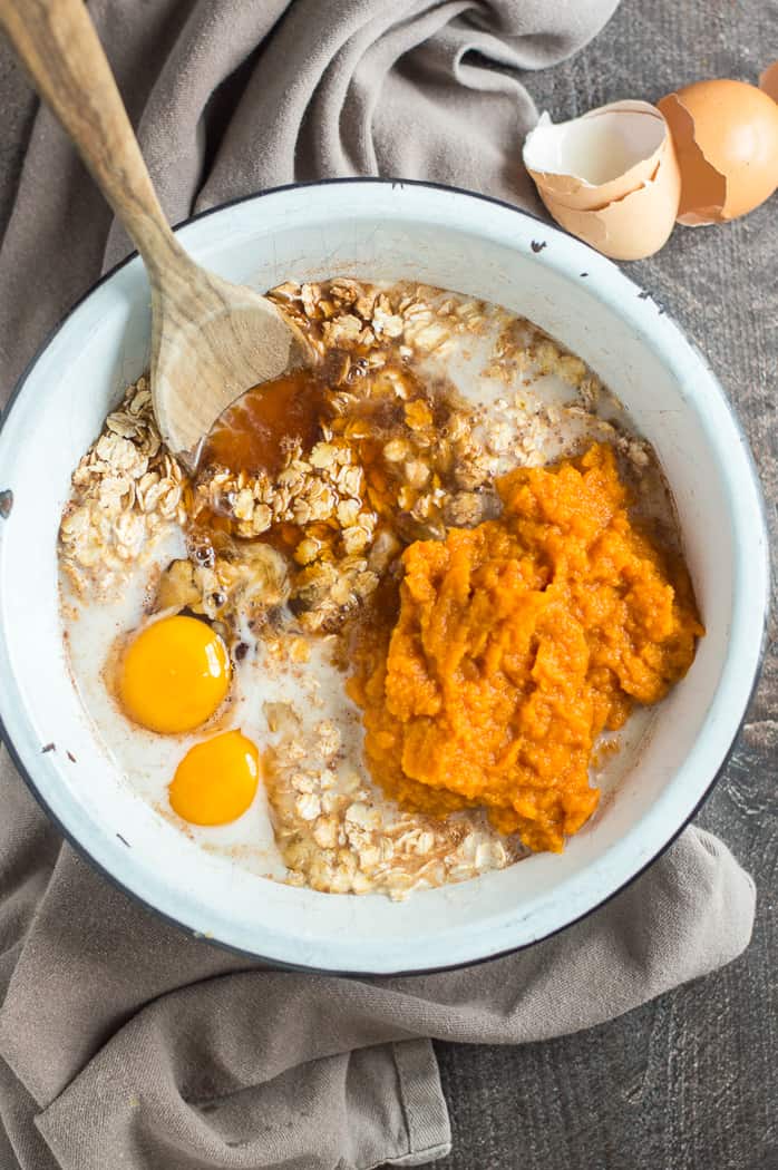 The ingredients for pumpkin baked oatmeal in a bowl before mixing.