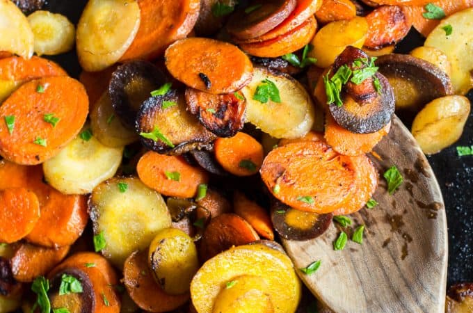 Easy 10-Minute Sautéed Carrots with a wooden spoon on top