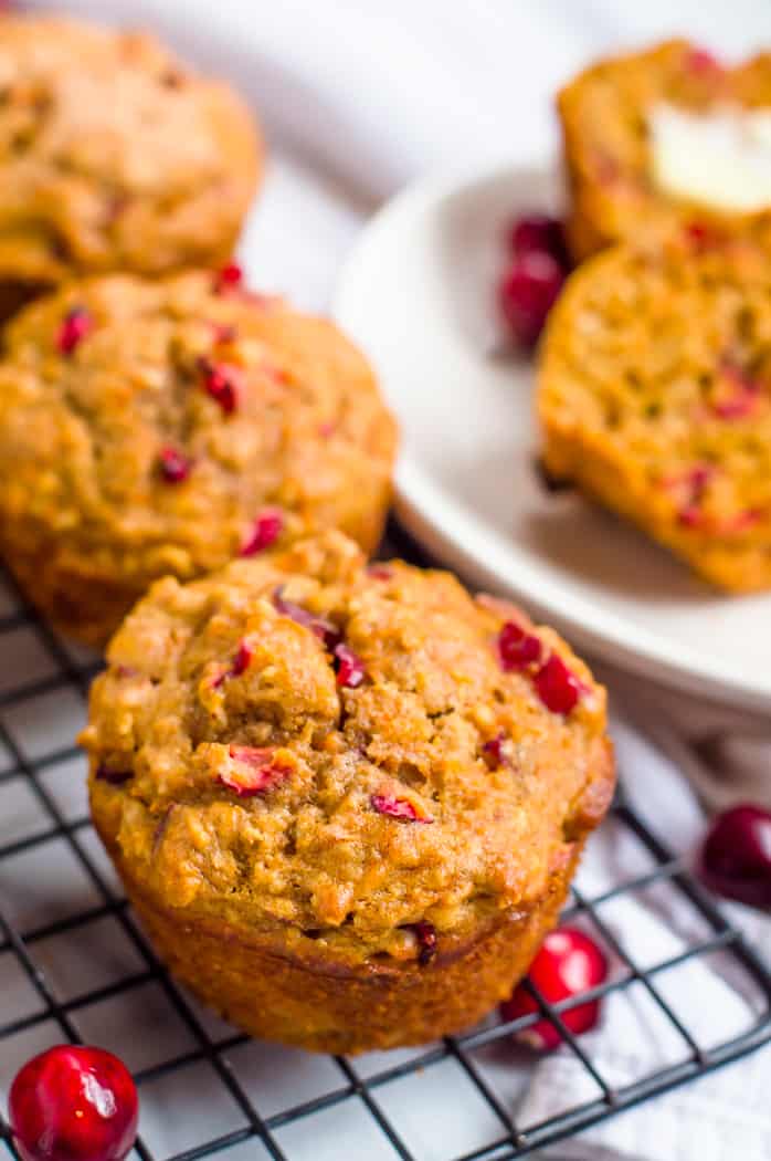 Cranberry orange carrot muffins on a cooling rack.