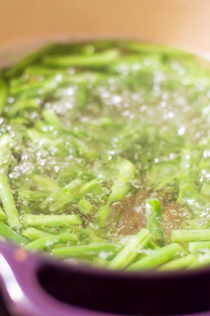 Green beans in a pot of boiling water.