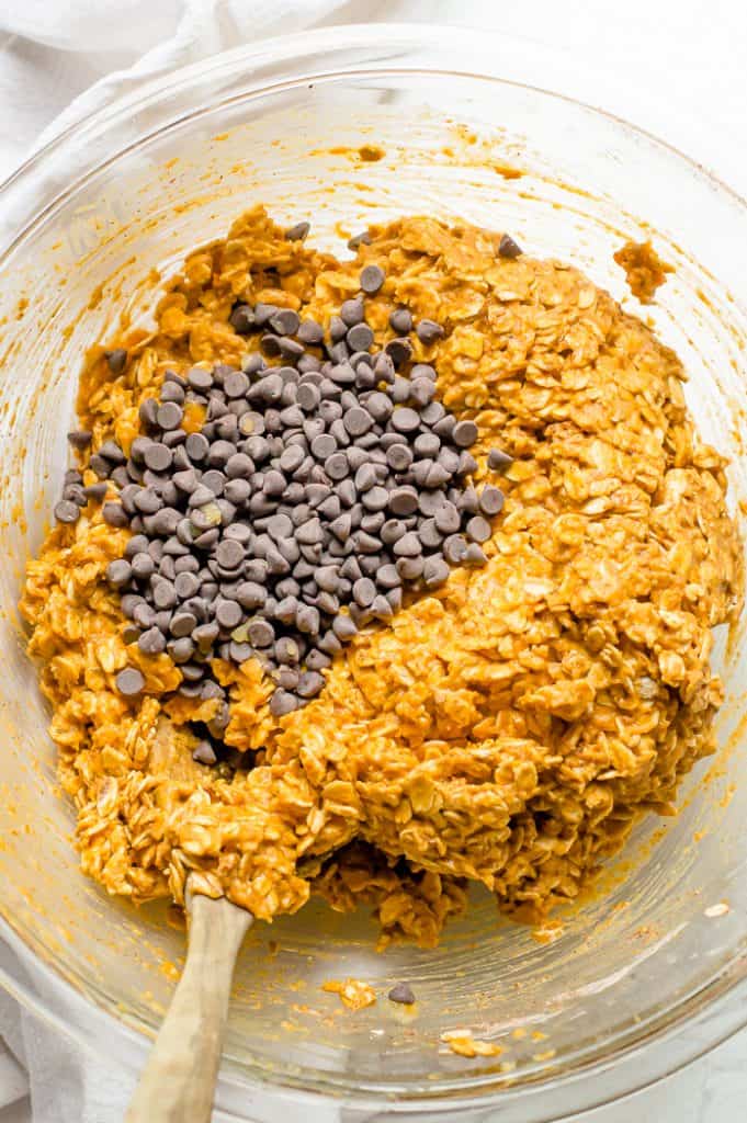 The batter for pumpkin oatmeal bars in a bowl with chocolate chips on top.