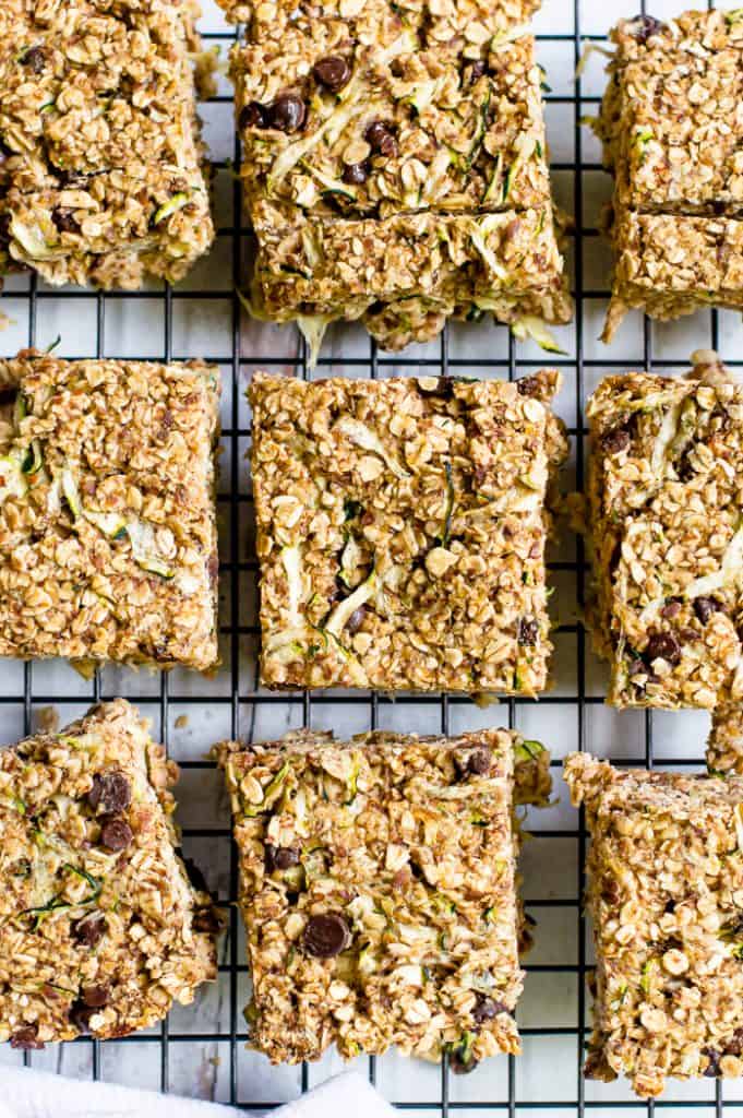 Banana zucchini oatmeal bars cut into squares on a cooling rack. 
