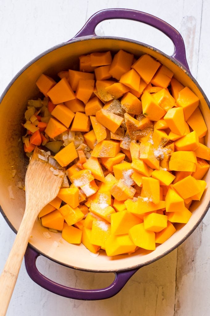 Dice kabocha squash in a pot with salt, pepper, spices and sauteed veggies.
