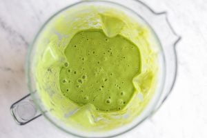Spinach pear smoothie in a blender after blending.