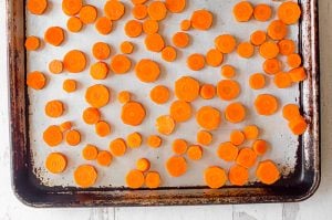 Sliced carrots on a baking sheet.