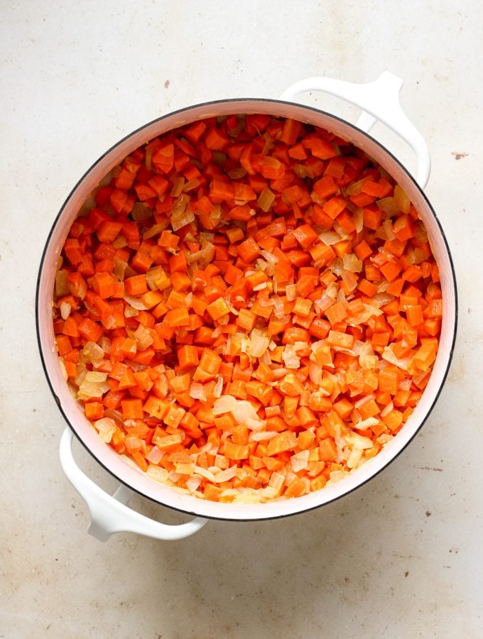 Diced carrots, garlic, and 1 teaspoon of salt in a pot after being sautéed. 