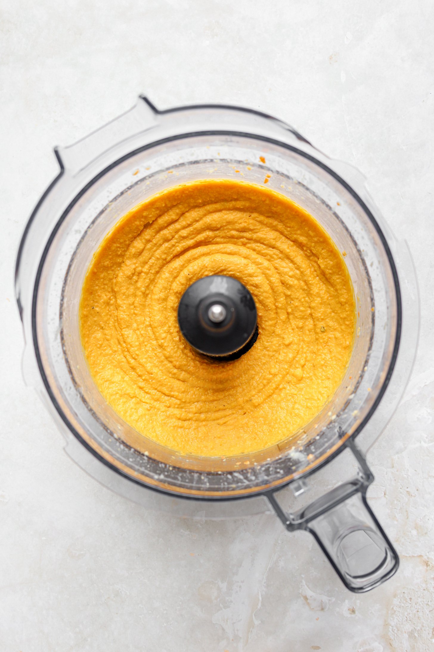 Pureed roasted chickpea hummus in a food processor. 