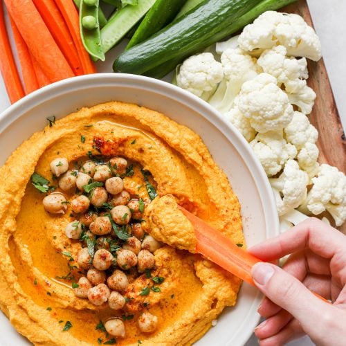 Dipping into the homemade Roasted Carrot Hummus