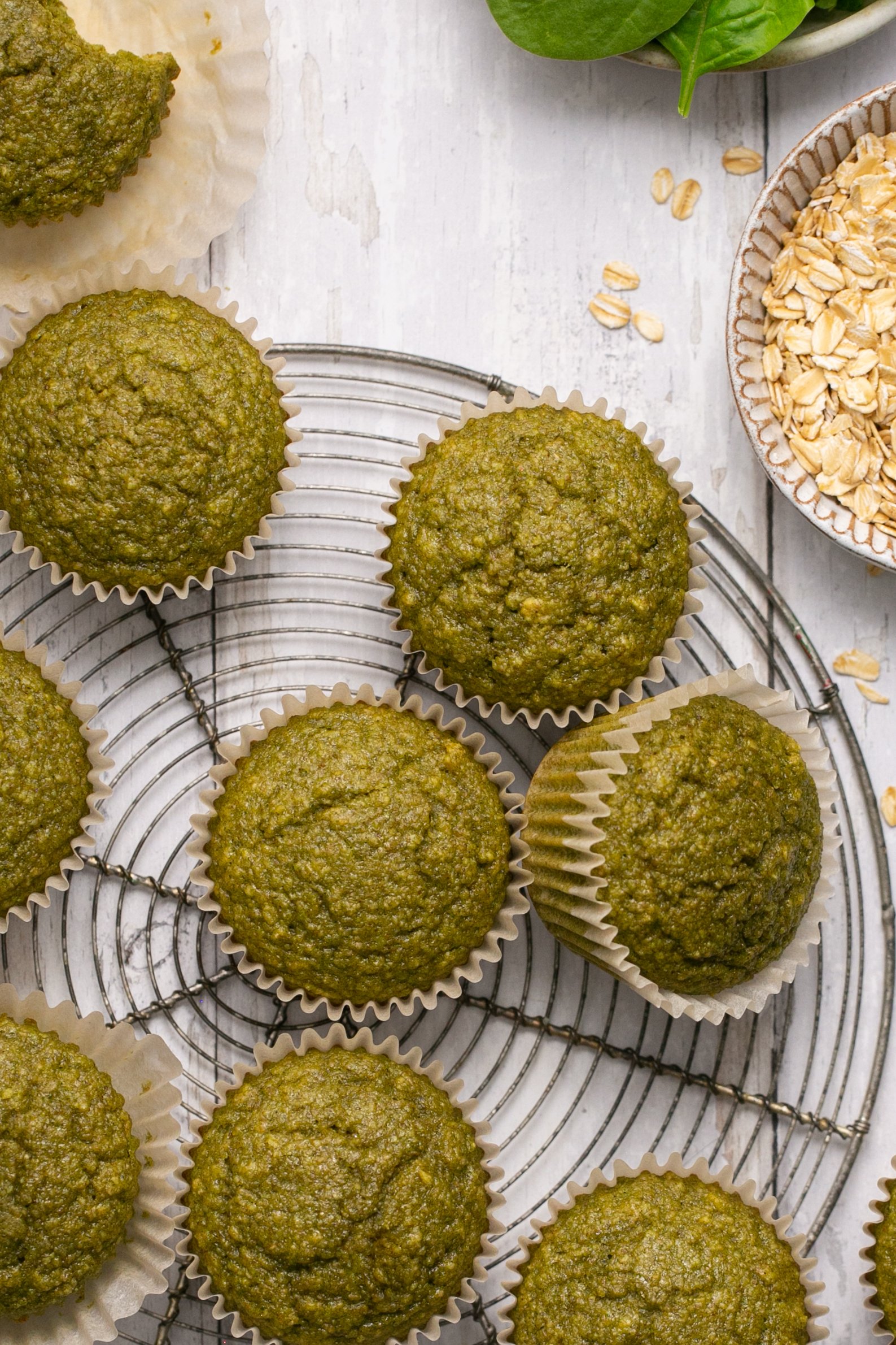 Oatmeal green smoothie muffins on a round cooling rack.
