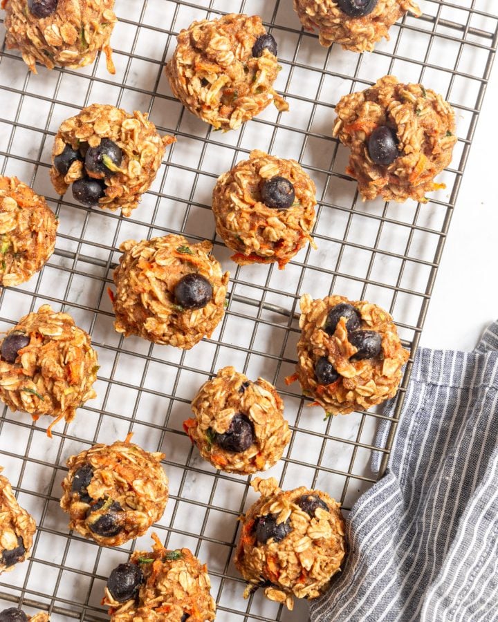 Baked veggie-loaded breakfast cookies on a cooling rack. There is a napkin next to the rack. 