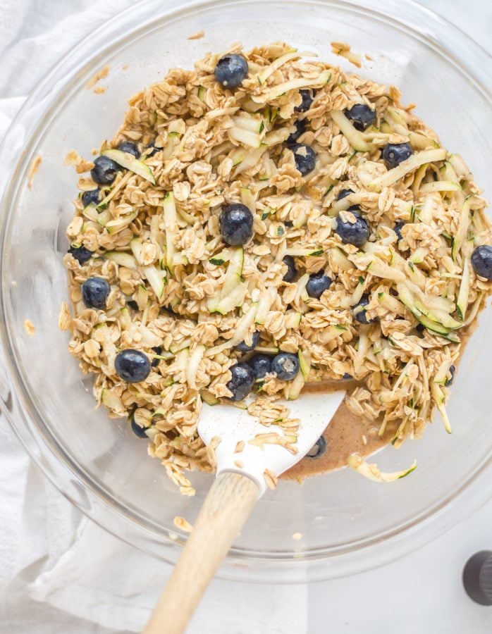 Ingredients for zucchini blueberry baked oatmeal all stirred together in a bowl.