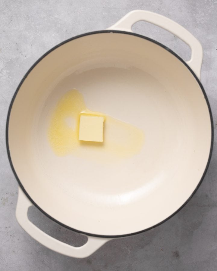 Butter being melted in a large white pot