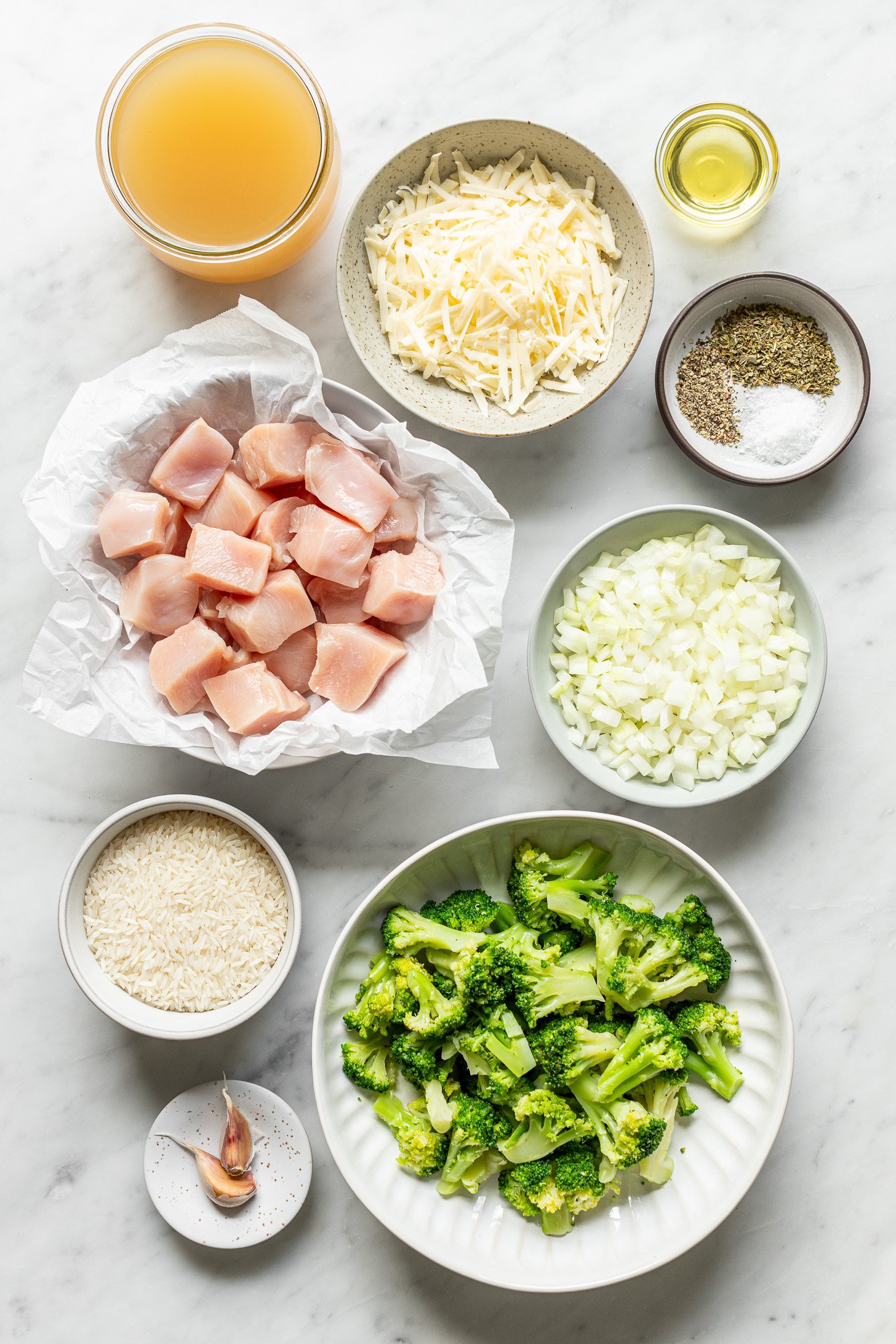 Ingredients for cheesy chicken and rice on the table before being cooked together.