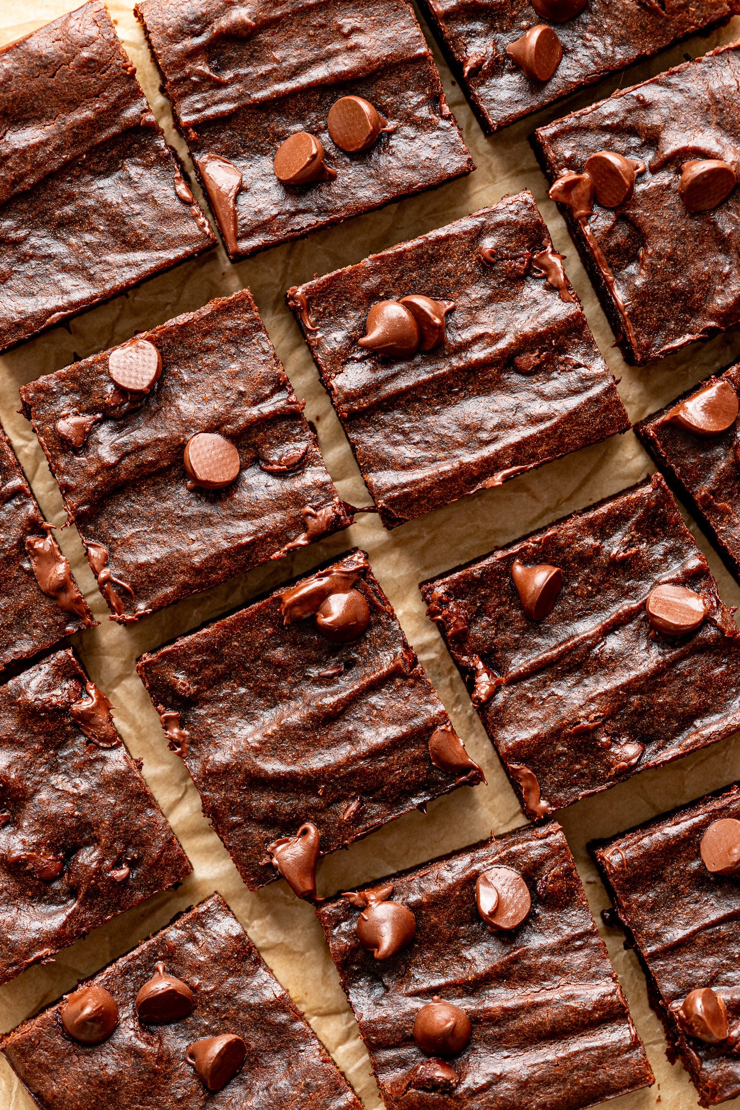Sweet potato brownies on a piece of brown parchment paper.